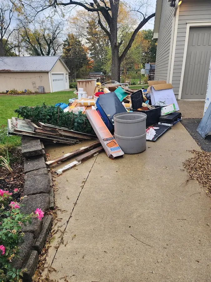 Dumpster being loaded with debris for Residential Dumpster Rental in Foley